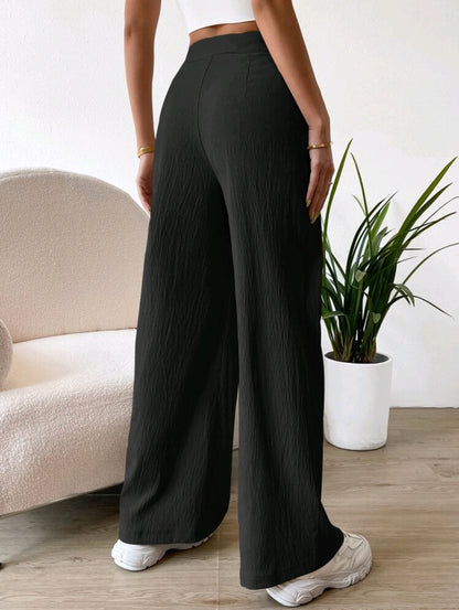 Pantalon à taille haute avec détails plissés et jambe large